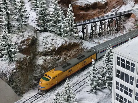 Personenzug unter einer Holzbrücke