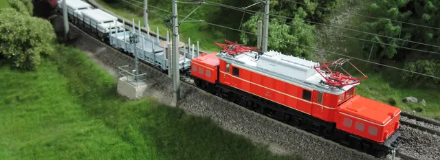 Rote Elektrolok auf grüner Modelllandschaft